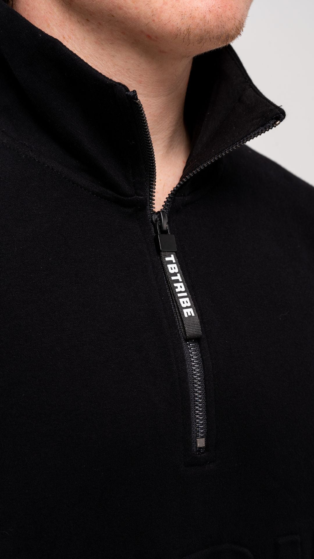 Oversized, black, fleece lined jumper with emboassed TB TRIBE logo, branded zipper tab, middle pocket and metal zipper