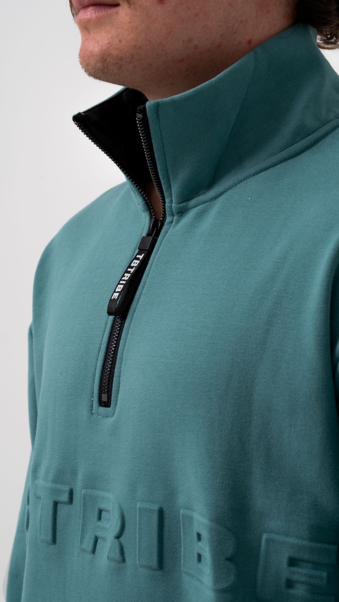 Oversized, faded teal colour, fleece lined jumper with emboassed TB TRIBE logo, branded zipper tab, middle pocket and metal zipper