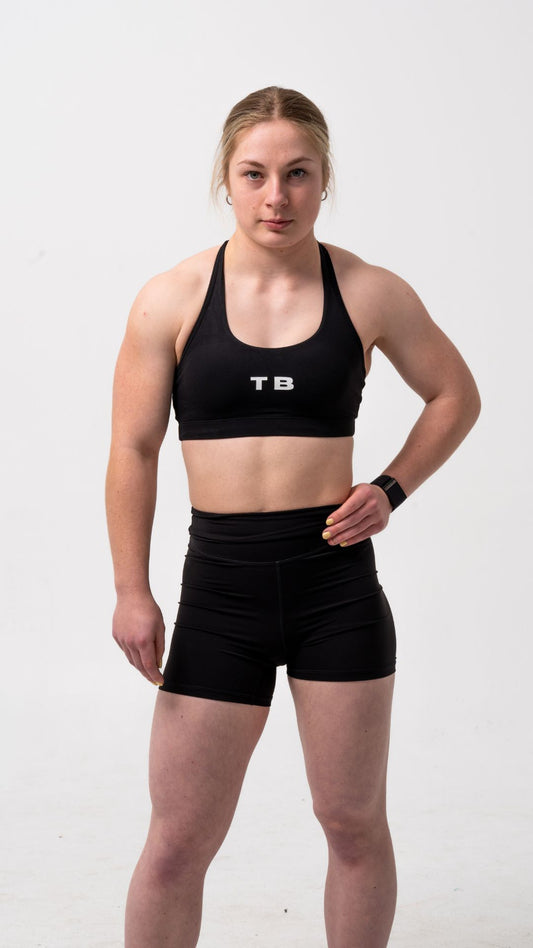 Black, racer back sports bra with white logo TB in the centre