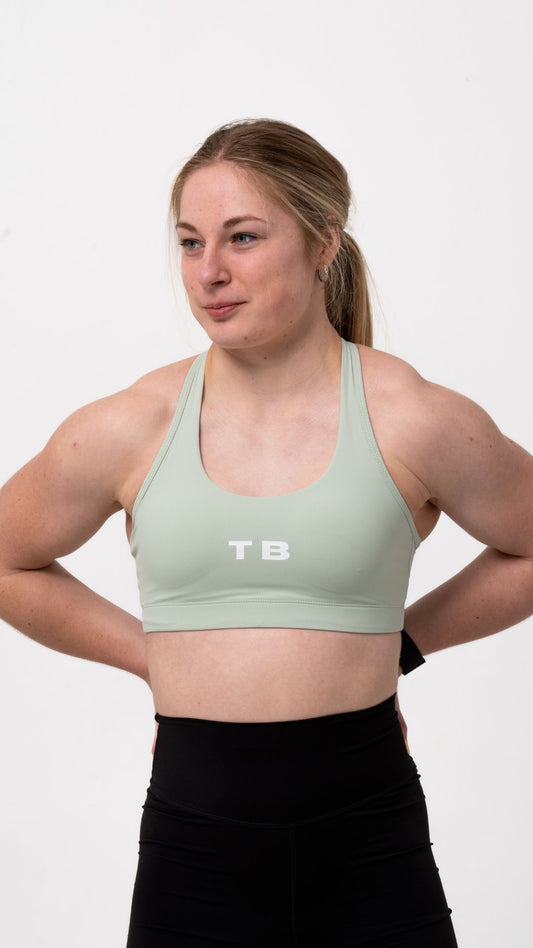 Mint green colour, racer back sports bra with white logo TB in the centre