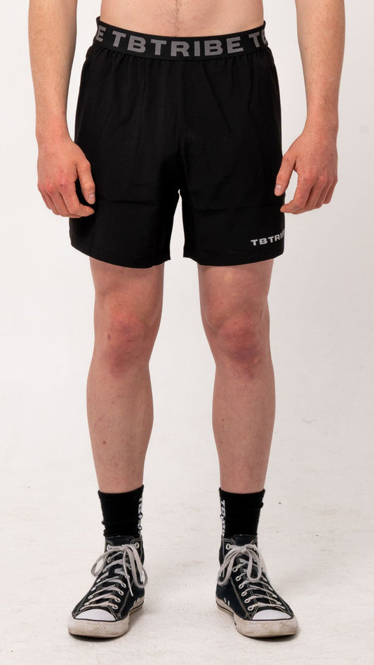 Black gym, training shorts with branded TB Tribe elastic waist band. Features side pockets with zippers, mesh panels on the side for ventilation and small TB Tribe logo on left leg
