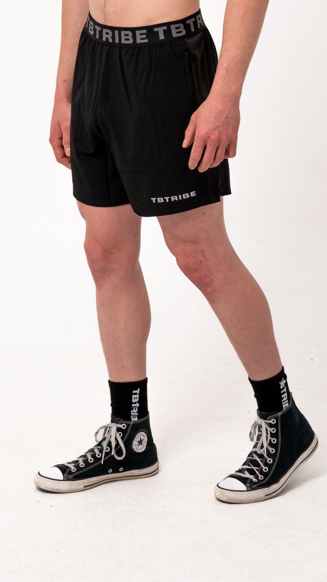 Black gym, training shorts with branded TB Tribe elastic waist band. Features side pockets with zippers, mesh panels on the side for ventilation and small TB Tribe logo on left leg